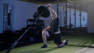 Fit-young-man-working-out-alone-in-the-gym-with-a-quick-15-Minute-Landmine-Workout.jpg